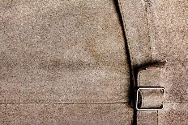 Texture backdrop photo of brown colored suede leather surface with belt. - Photo, Image