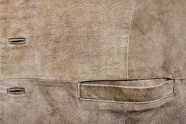 Texture backdrop photo of brown colored suede leather pocket and buttonholes. - Photo, Image