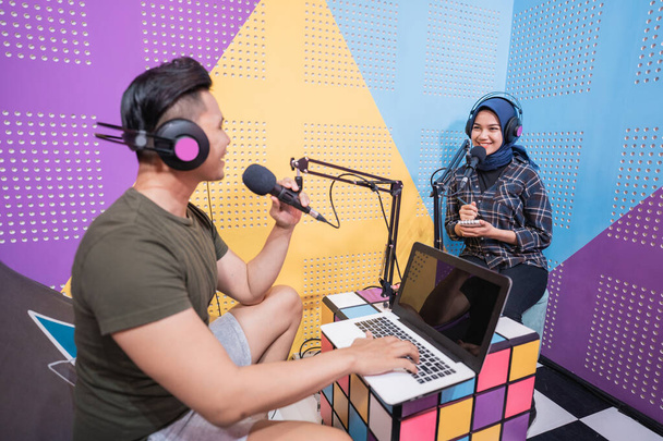 man and woman during live interview in podcast studio together - Foto, Imagen