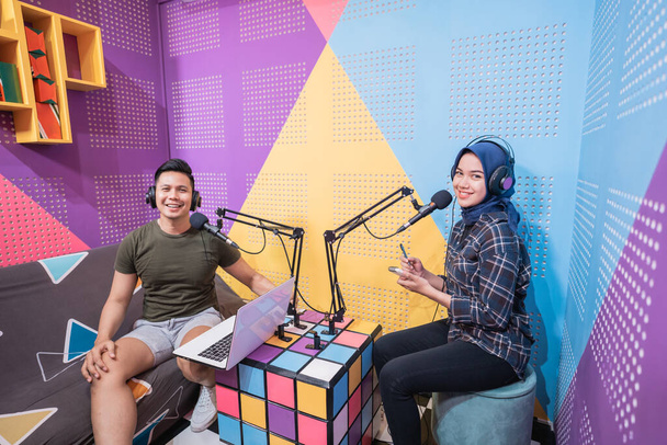 man and woman during live interview in podcast studio together - Photo, image