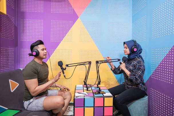 man and women discussing on live streaming during podcast - Photo, Image