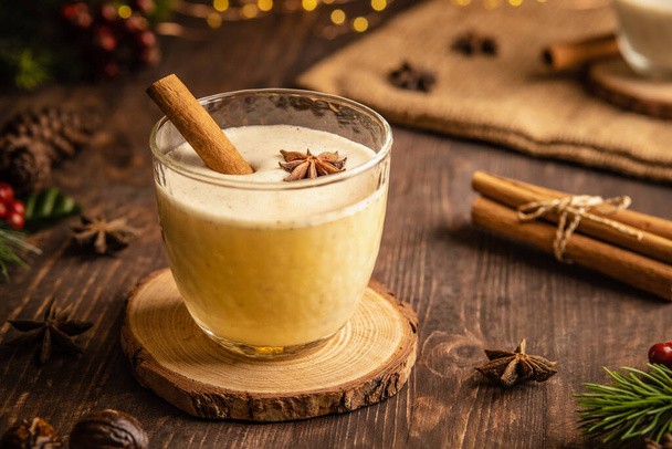 Eggnog with spicy cinnamon for Christmas and winter holidays,Cozy cocktail with milk and cinnamon and clove stars,Traditional Christmas drink with grated nutmeg and cinnamon,Homemade White Holiday - Photo, Image