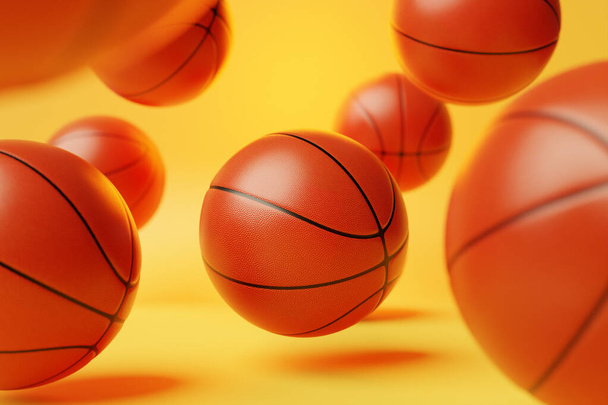 Basketbol toplarının üç boyutlu çizimi. Bir sürü turuncu basketbol topu sarı izole bir arka planda uçuyor. Spor toplarıyla gerçekçi canlandırma - Fotoğraf, Görsel