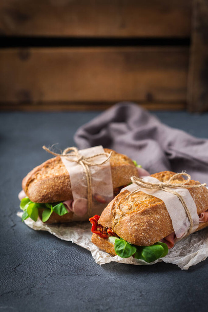 Fresh rye bread sandwich with ham, lettuce and tomato - Photo, image