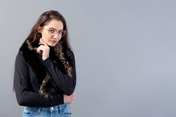 portrait of sensual female in glasses  with long hair against gray background - Fotografie, Obrázek