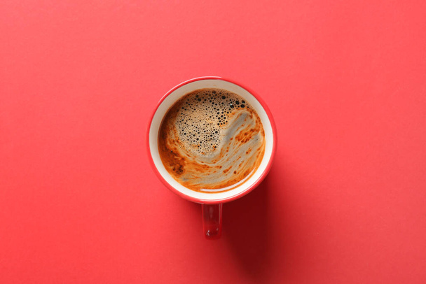 Cup of coffee on red background - Fotó, kép