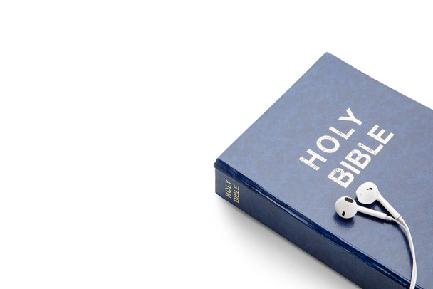 Holy Bible and earphones on white background, closeup - Foto, Imagem