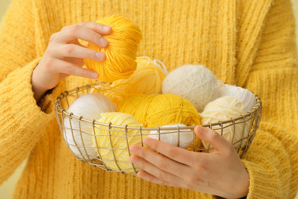 Woman holding basket with knitting yarn, closeup - Foto, Imagem
