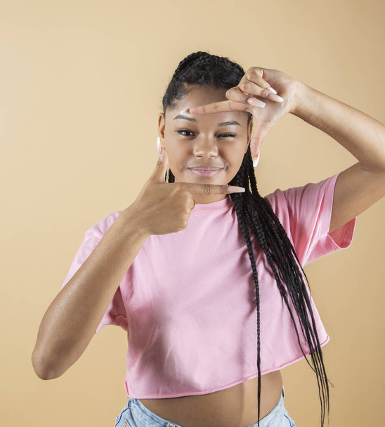 young afro woman makes photo gesture in studio - Photo, Image