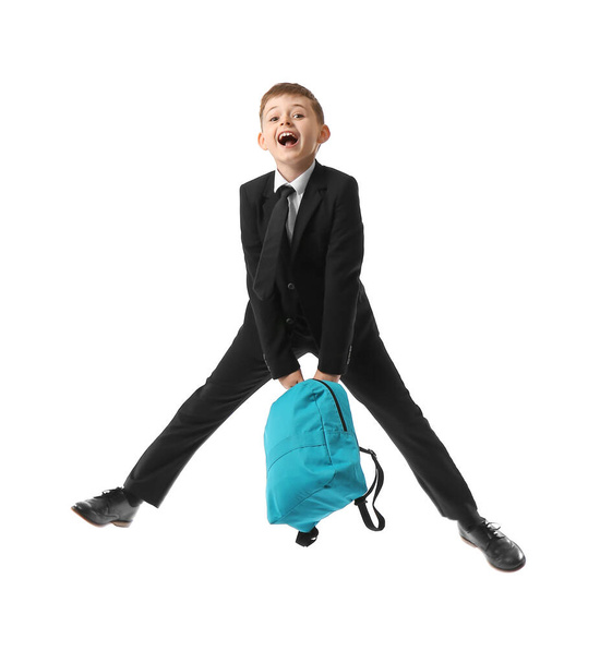 Jumping little schoolboy with backpack on white background - Foto, immagini