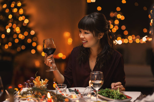 happy asian woman drinking wine at christmas party - Zdjęcie, obraz