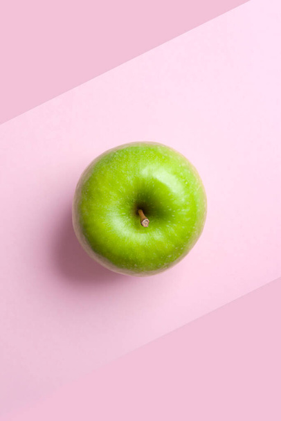 top view whole isolated granny smith green apple on pink background vertical - 写真・画像