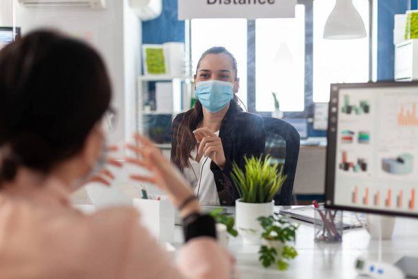 Business team wearing medical face mask to prevent infection with coronavirus - 写真・画像