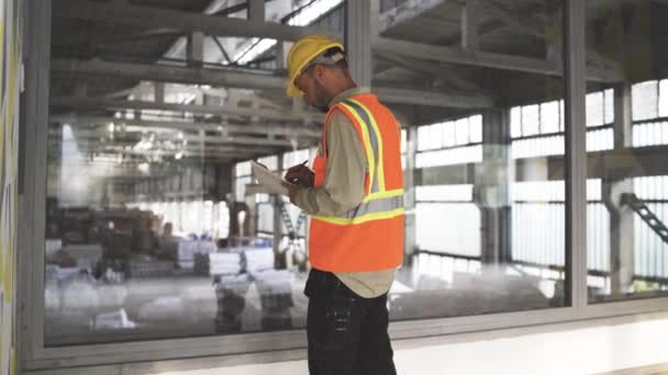 Young Engineer Man Analyzing at construction site - Footage, Video