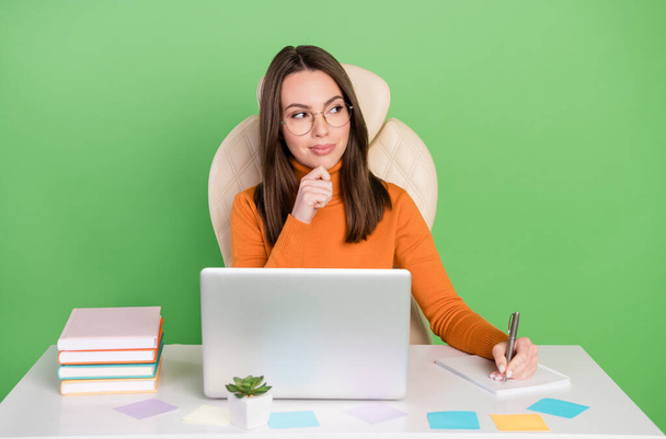 Portrait of attractive cheery trendy skilled minded girl creating strategy writing to-do list isolated over bright green color background - Фото, изображение