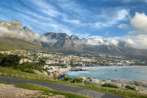 Scenic view of Camps Bay, South Africa with twelve apostles in the background against blue sky with clouds in the evening - Photo, Image