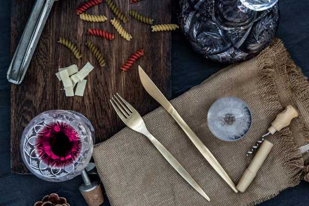 Flat lay composition with pitcher and glasses of red wine and corkscrew on wooden background : traditional winemaking and wine tasting concept, Free space for text. - Photo, Image