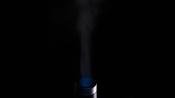 Steam from the ultrasonic humidifier isolated on a black background. Concept. Healthcare, climate change, extreme close up of an air humidifier nozzle. - Photo, Image