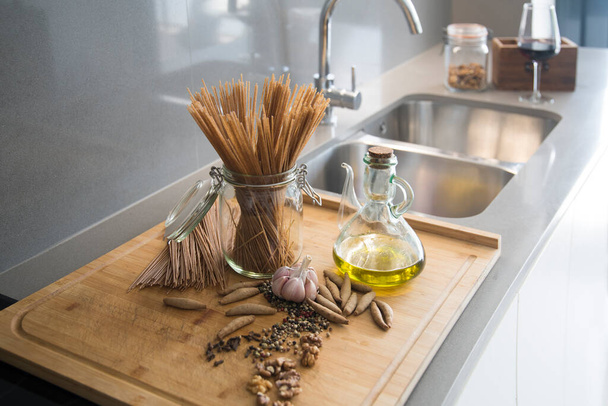 Kitchen table with spaghetti oil and spices - 写真・画像