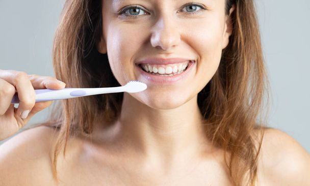 Close up of toothbrush in front of woman. Oral and dental health concept. - Fotoğraf, Görsel