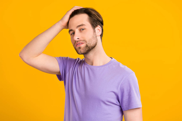 Photo of masculine virile guy touch perfect smooth silky hairdo wear purple t-shirt isolated yellow color background - Photo, image