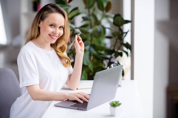 Photo portrait woman blonde hair wearing white clothes working from home with laptop keeping pen - Photo, image