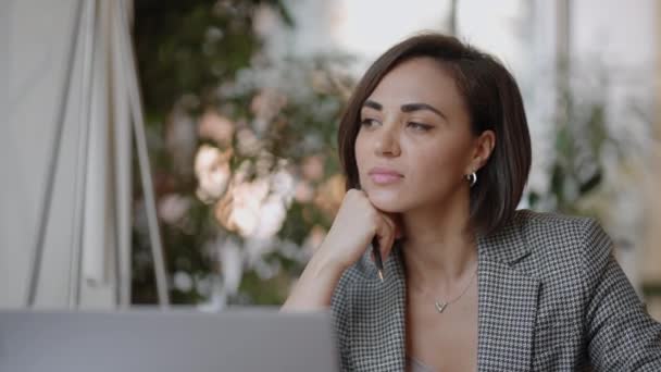 Arabian Hispanic woman working financial paperwork seated at workplace using laptop looks concentrated while makes task, prepare, check report having fruitful workday. Student learning process concept - Footage, Video