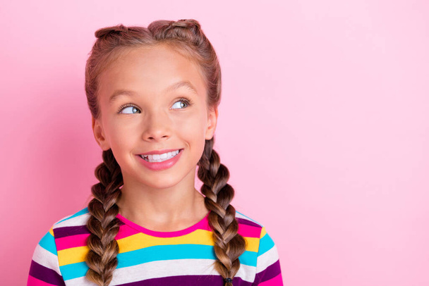 Photo of cheerful interested little lady look empty space toothy smile wear striped shirt isolated pink color background - Fotoğraf, Görsel