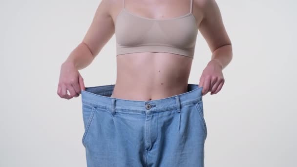 Slim girl on oversized shorts, pants, dancing - Footage, Video