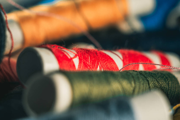 A selective focus shot of spools of threads - 写真・画像