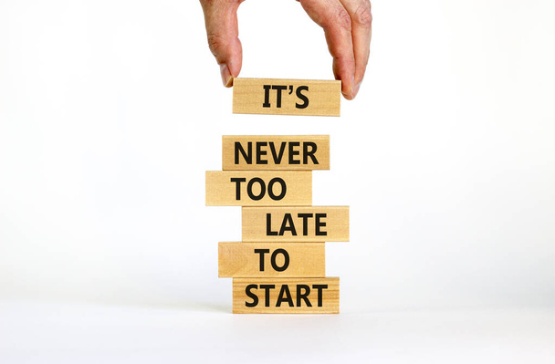 Success start symbol. Wooden blocks with words 'It is never too late to start'. Businessman hand. Beautiful white background, copy space. Business and It is never too late to start concept. - Foto, Bild