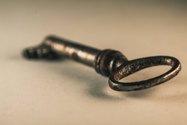 A selective focus shot of an aged dirty key - Zdjęcie, obraz