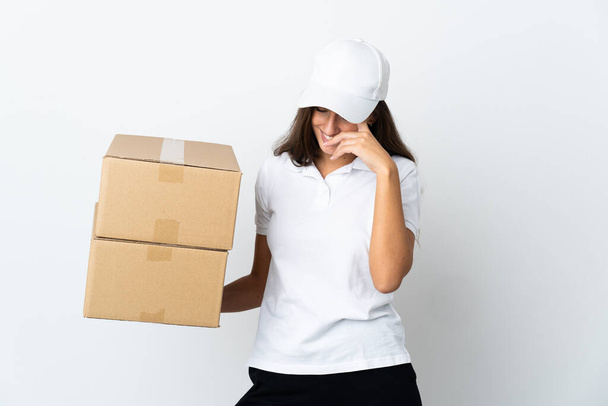 Young delivery woman over isolated white background laughing - Foto, Imagem