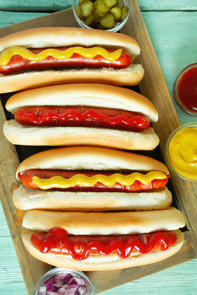 hot dogs with mustard and ketchup on wooden background - Foto, Imagem