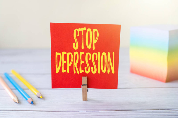 Sign displaying Stop Depression. Concept meaning end the feelings of severe despondency and dejection Blank Sticky Note Laundry Clip Stack Of Colorful Paper Pen Placed On Desk. - Photo, Image