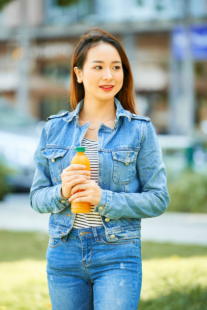 Smiling Woman with Juice Bottle - 写真・画像