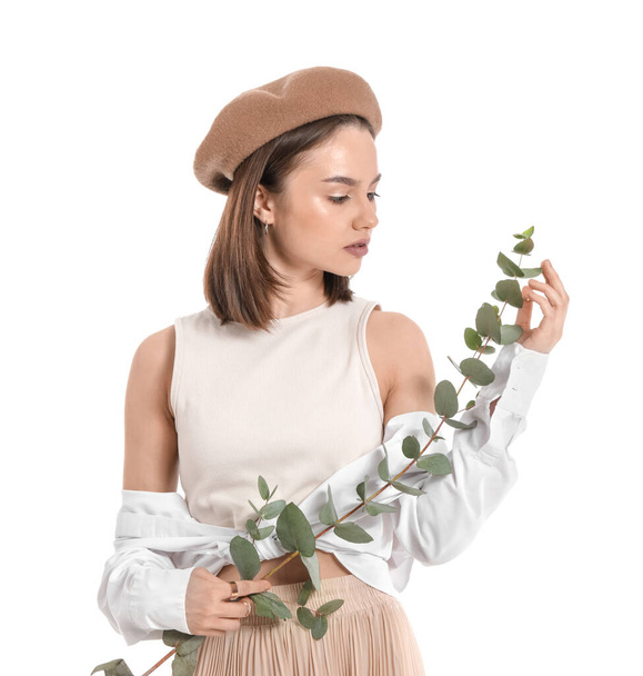 Beautiful young woman with eucalyptus branch on white background - Photo, Image