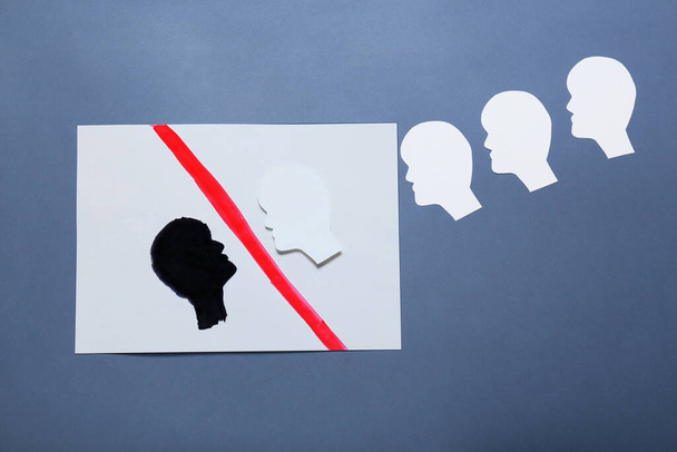 Paper human heads on blue background. Concept of racism - Photo, Image