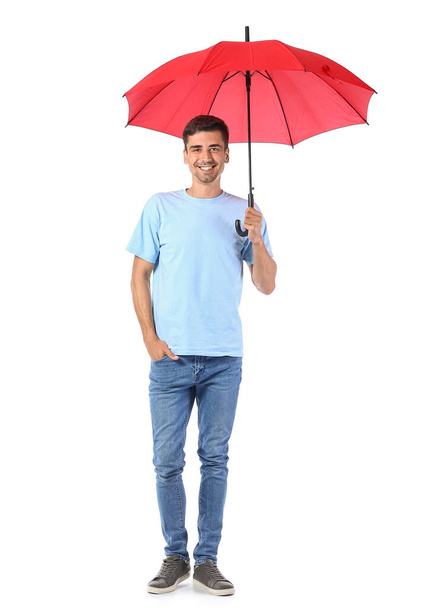 Красивый молодой человек с зонтиком на белом фоне - Фото, изображение