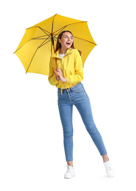 Beautiful young woman with umbrella on grey background - Foto, Imagen