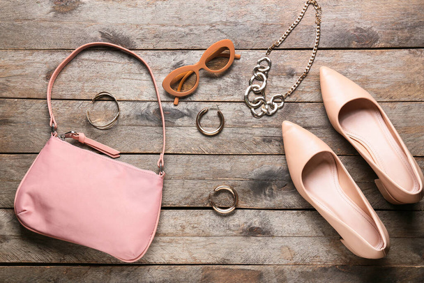 Stylish female handbag and accessories on wooden background - Photo, Image