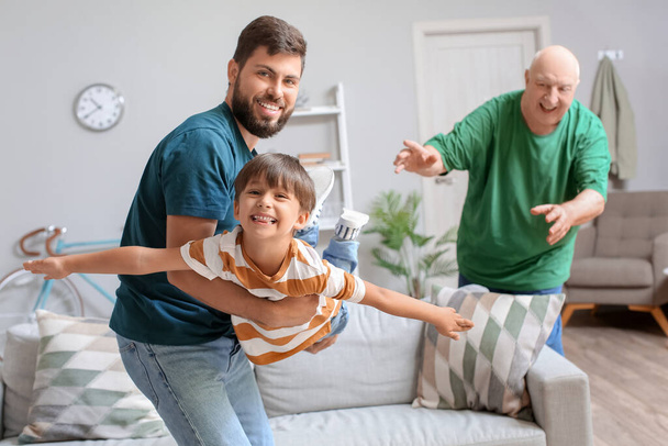 Happy man, his little son and father at home - Photo, Image