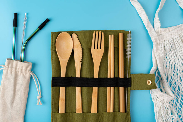 Zero waste a set of cutlery made of wood, bamboo, forks, knife, bamboo straws. waste reduction. reusable use. - Photo, Image