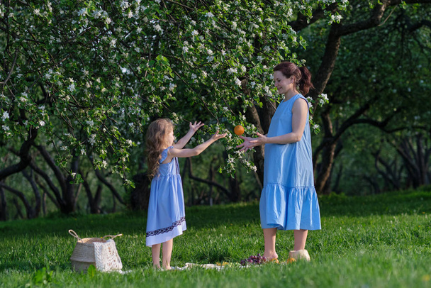 家族のアウトドアライフスタイルと自然シーン。母と娘が公園で遊んでいる。幸せな家族の概念。家庭生活における幸福と調和. - 写真・画像