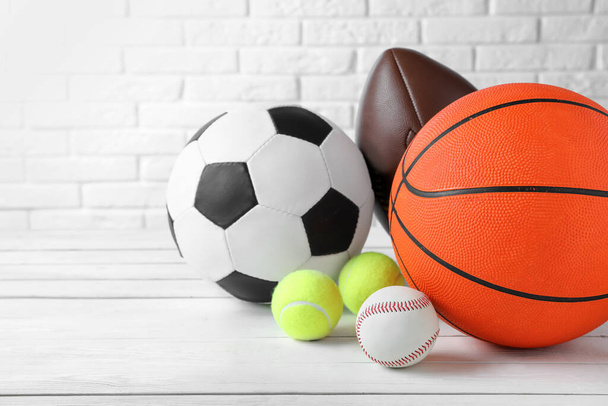 Set of different sport balls on white wooden table. Space for text - Photo, image