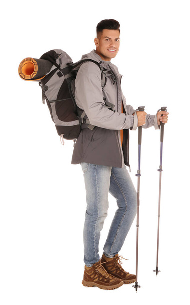Male hiker with backpack and trekking poles on white background - Photo, Image