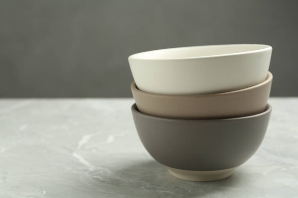 Stylish empty ceramic bowls on grey table, space for text. Cooking utensils - Photo, image