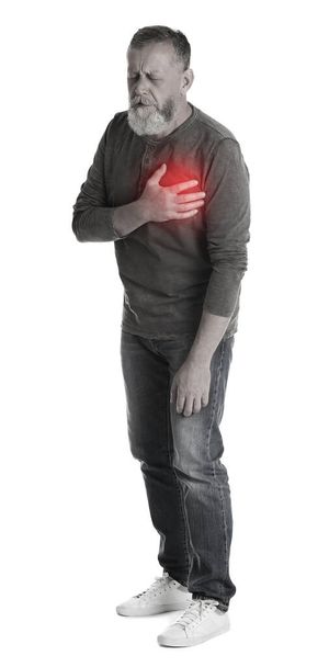 Mature man having heart attack on white background - Фото, изображение