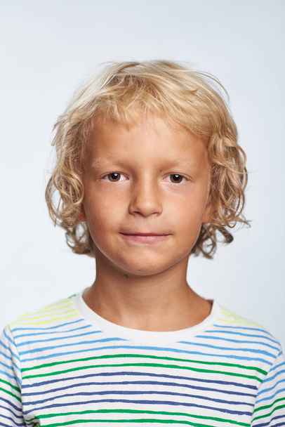 Boy curly blond 7 years old photo for document on white background - Foto, Imagem