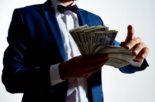 man in a suit dollars millionaire light background - Fotoğraf, Görsel